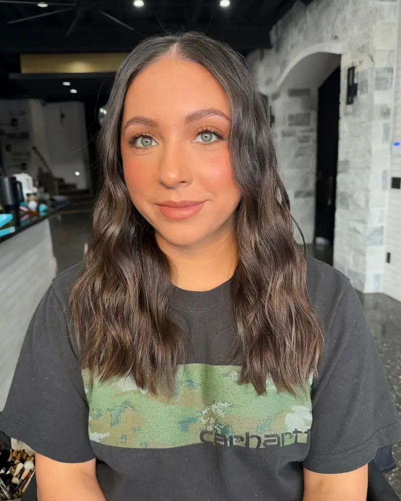 Alli McBee headshot with long wavy hair